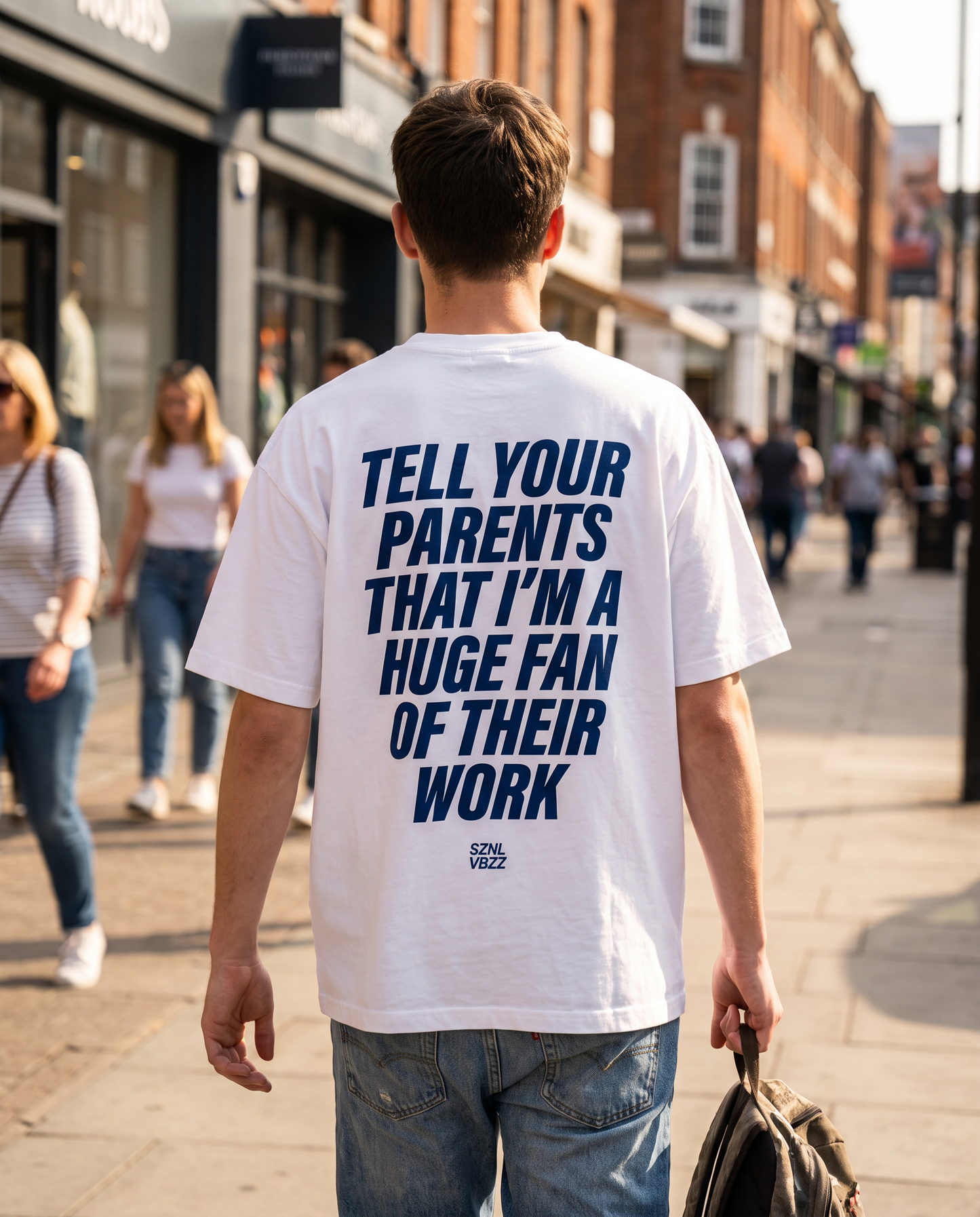 Oversized white tee with blue Tell Your Parents back print, street style
