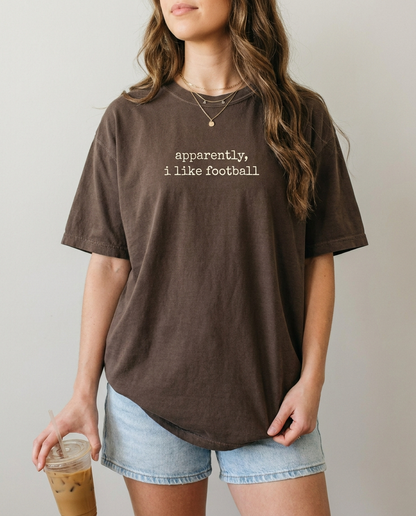 Woman wearing apparently i like football espresso Comfort Colors tee
