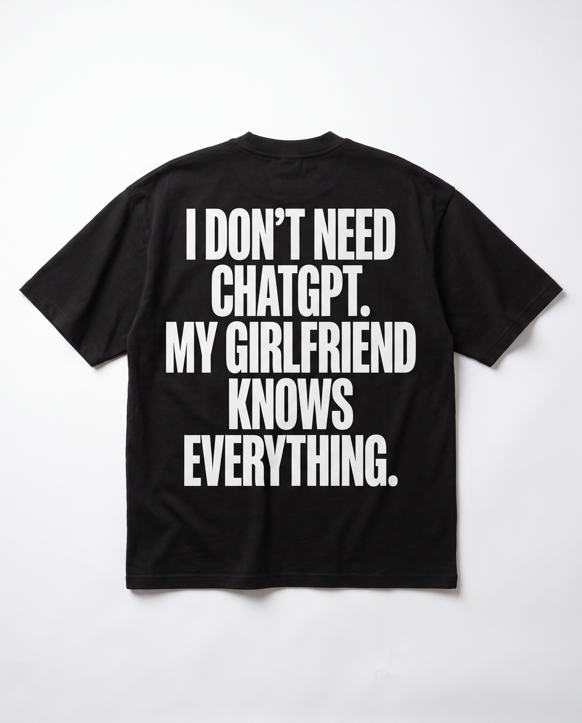I Don't Need ChatGPT tee — white back print on black heavyweight oversized tee, flat lay