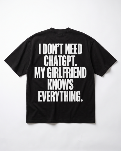 I Don't Need ChatGPT tee — white back print on black heavyweight oversized tee, flat lay