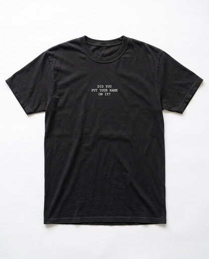 Did You Put Your Name On It tee — small white chest print on black Comfort Colors tee, flat lay
