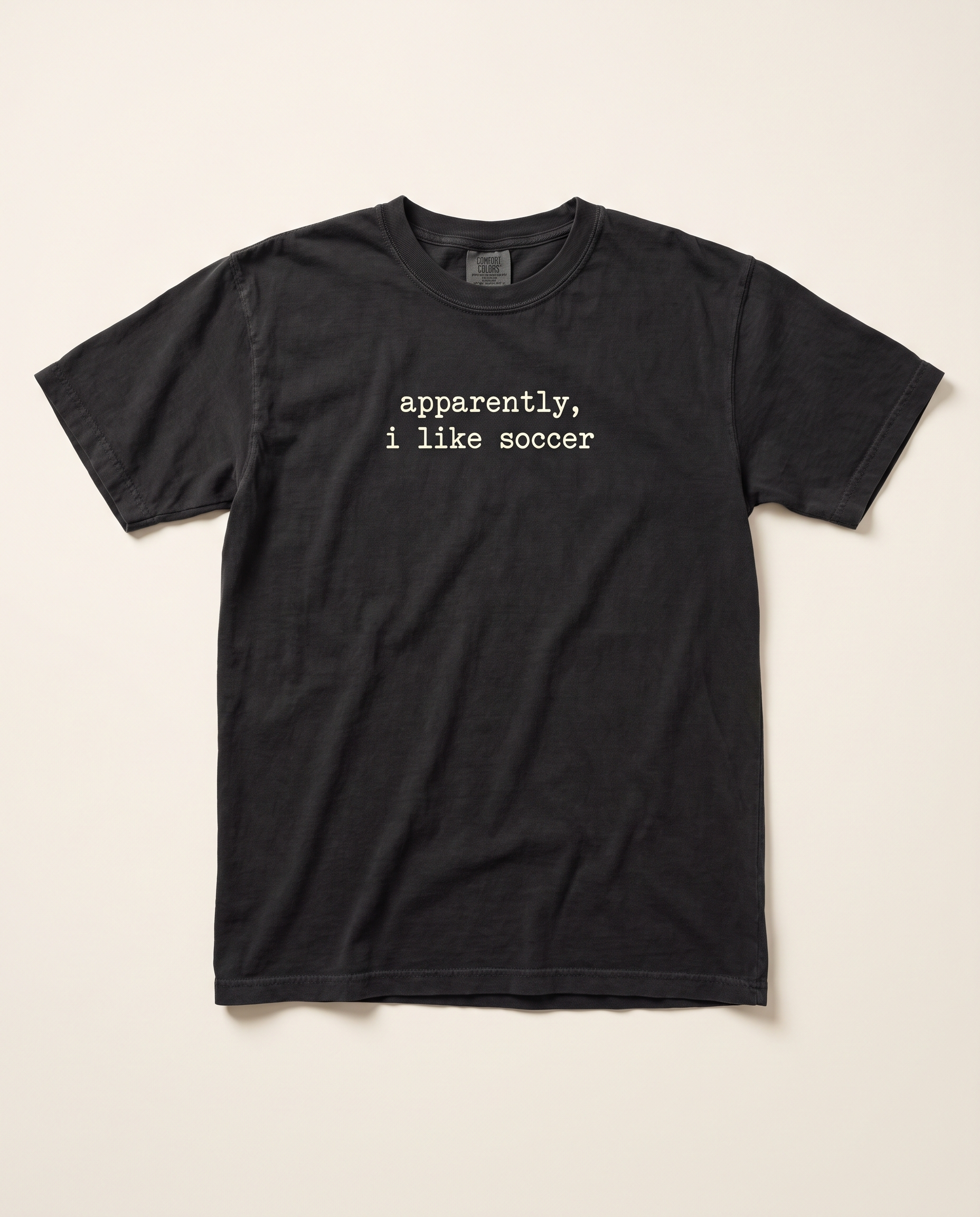 Apparently I Like Soccer tee, black flat lay