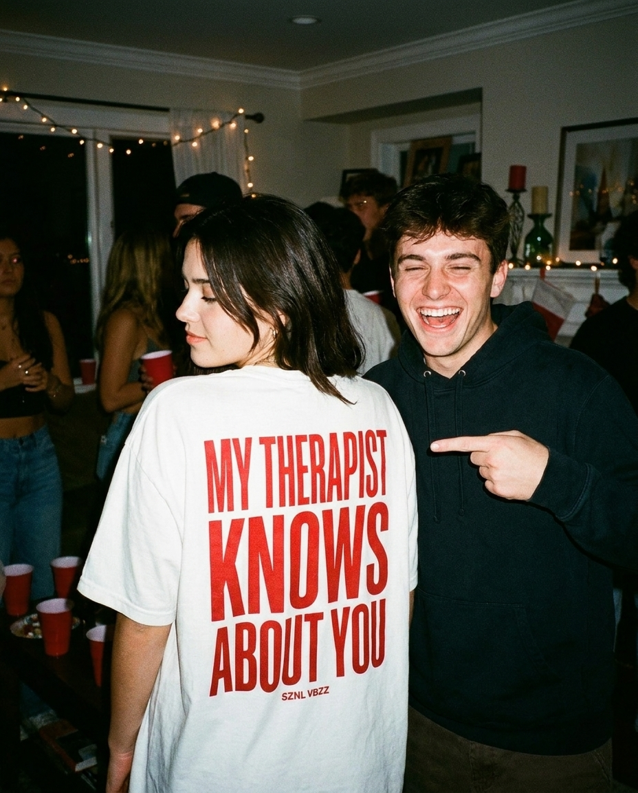 Friend laughing and pointing at the My Therapist Knows About You back print at a party