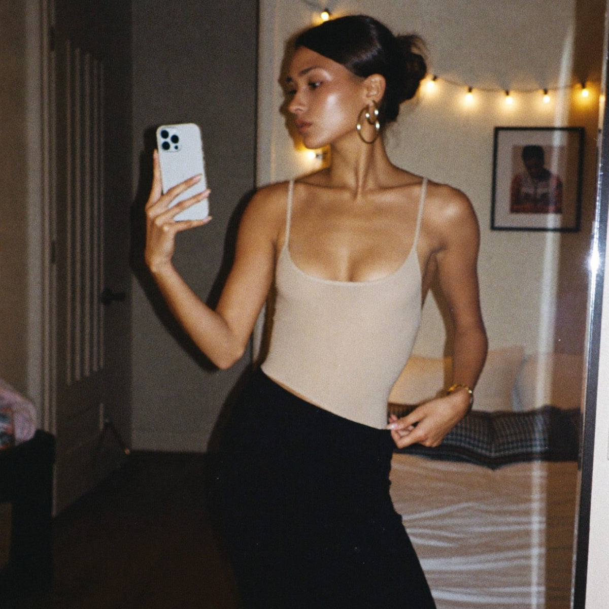 Nude seamless bodysuit worn as a top with a skirt